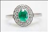 18ct white gold, claw set, emerald and diamond cluster ring.