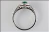 18ct white gold, claw set, emerald and diamond cluster ring.