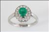 18ct white gold, claw set, emerald and diamond cluster ring.