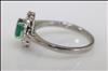 18ct white gold, claw set, emerald and diamond cluster ring.
