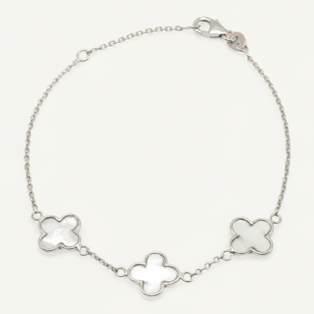 Silver bracelet with clover-shaped links on a white background