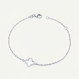 Silver clover bracelet on a light grey background